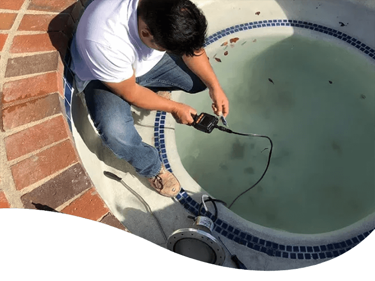 Pool Pirates' LeakTronics technician working on pool leak